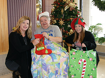 <strong>Santa's Elves making Christmas morning special by delivering gifts to local seniors</strong> <br />(from left to right): <strong>Karin Sitko</strong>, volunteer; <strong>Maria Lassonde</strong>, gift recipient; <strong>Rachel Meyer</strong>, Elf