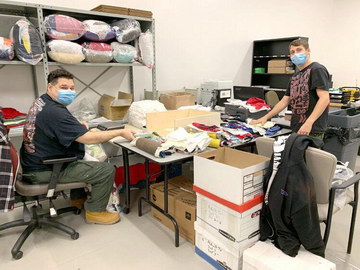 St. Joseph's Care Group Team Werks clients Bruno, left, and William, weigh cut rags and package them in the Rag Werks workshop for distribution to cleaning organizations.